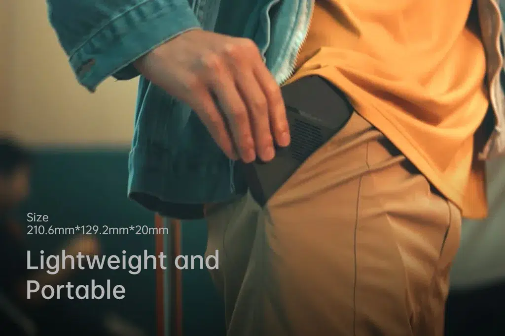 gempages522757109238989843ded664d6df3743e19237016fcf23d2c1 DROIX Global Close up of the ONEXPLAYER X1 Mini being slipped into a pocket showcasing its compact dimensions 2106mm x 1292mm x 20mm and lightweight design