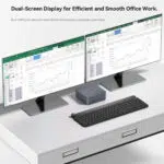 A compact desktop setup featuring dual monitors connected to a Beelink mini PC Each screen displays spreadsheets suggesting multitasking capabilities ideal for office productivity The text highlights the dual HDMI ports enabling seamless dual screen functionality to enhance workflow