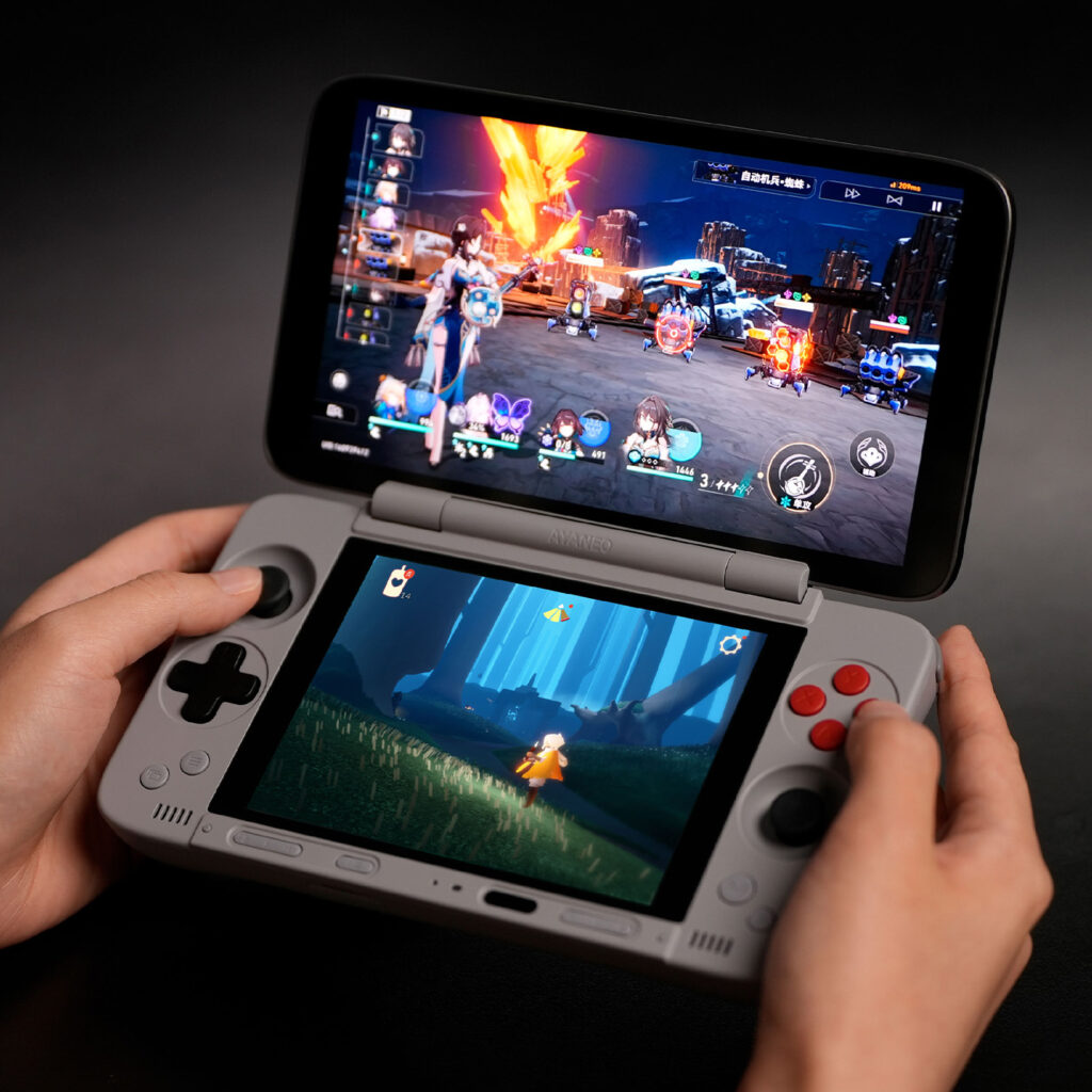 AYANEO Pocket DS 1 A person's hands holding the AYANEO Pocket DS, demonstrating the dual-screen functionality by playing two different games at once on the Android handheld.