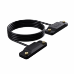 ONEXPLAYERAPEXBATTERYCABLELISTINGDONE01 DROIX Global An image of the ONEXPLAYER APEX Battery Interface cable The product consists of a long coiled black cable connecting two identical rectangular black plastic blocks Each block features the APEX battery interface logo embossed on the top surface and is equipped with two small gold colored knurled thumbscrews at the ends for secure attachment The entire assembly is displayed against a solid black background